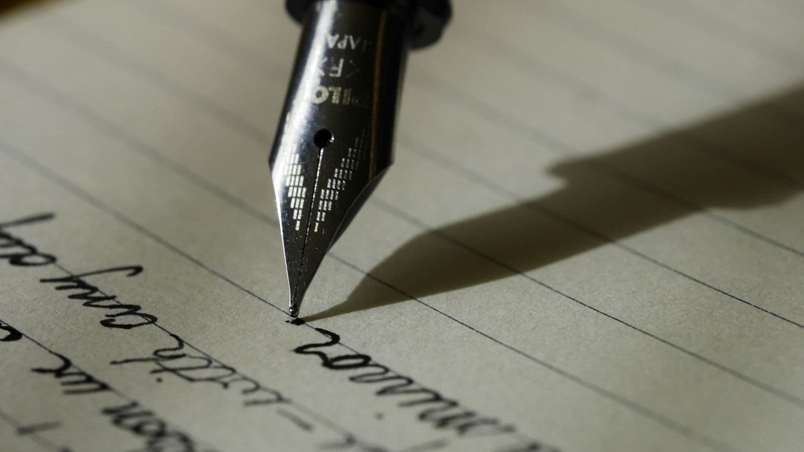 Close-up of a fountain pen writing on a page