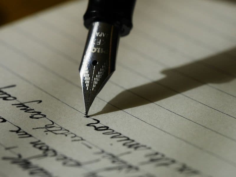 Close-up of a fountain pen writing on a page