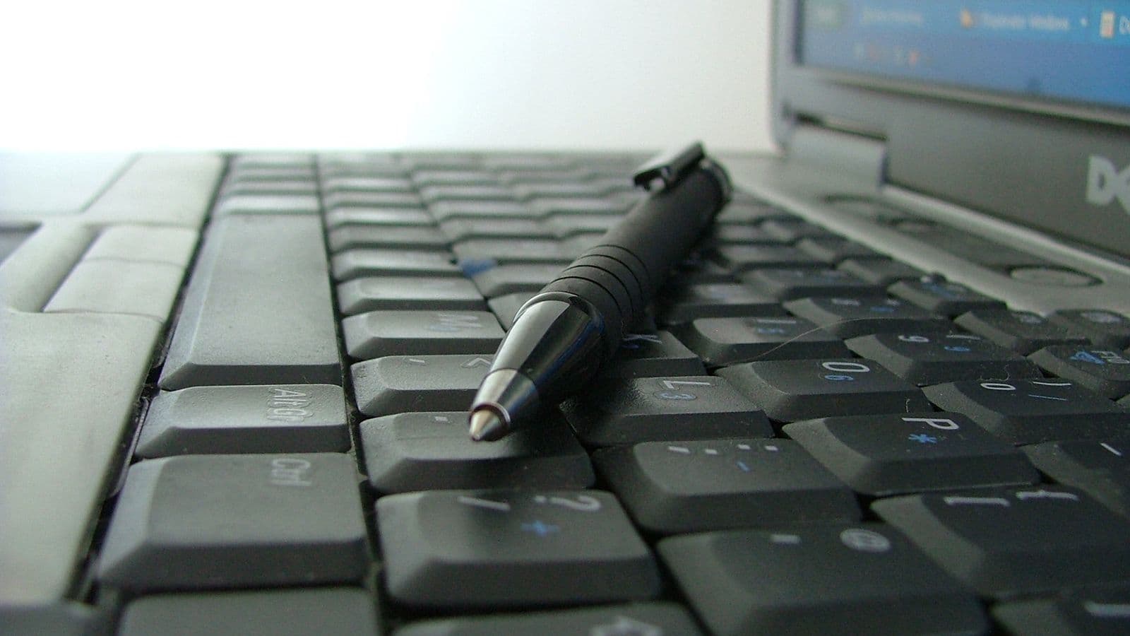 Keyboard and pen on a desk