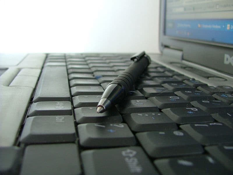 Keyboard and pen on a desk